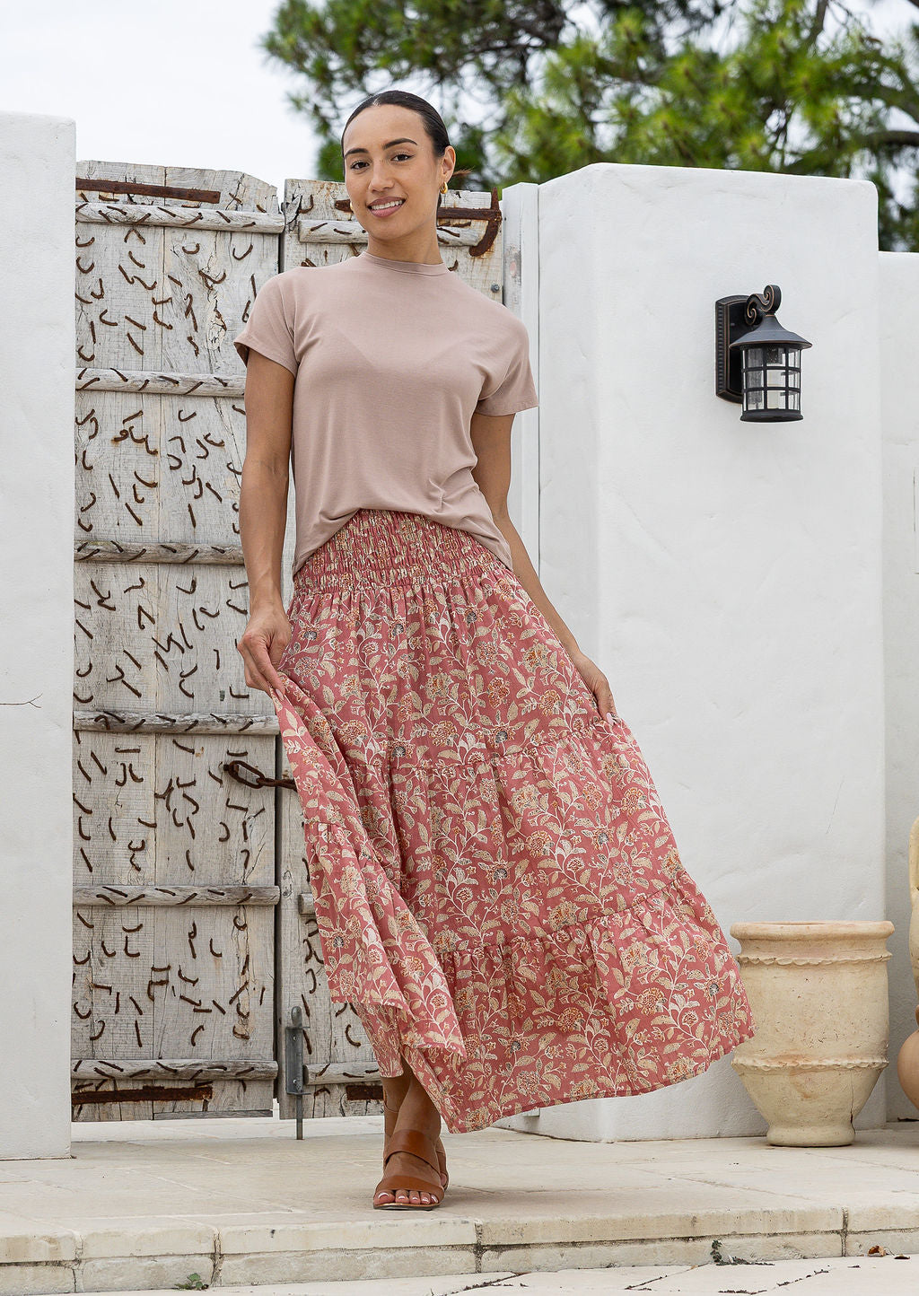 Model flaunting rose pink based floral print cotton maxi skirt with a wide shirred elastic waistband.