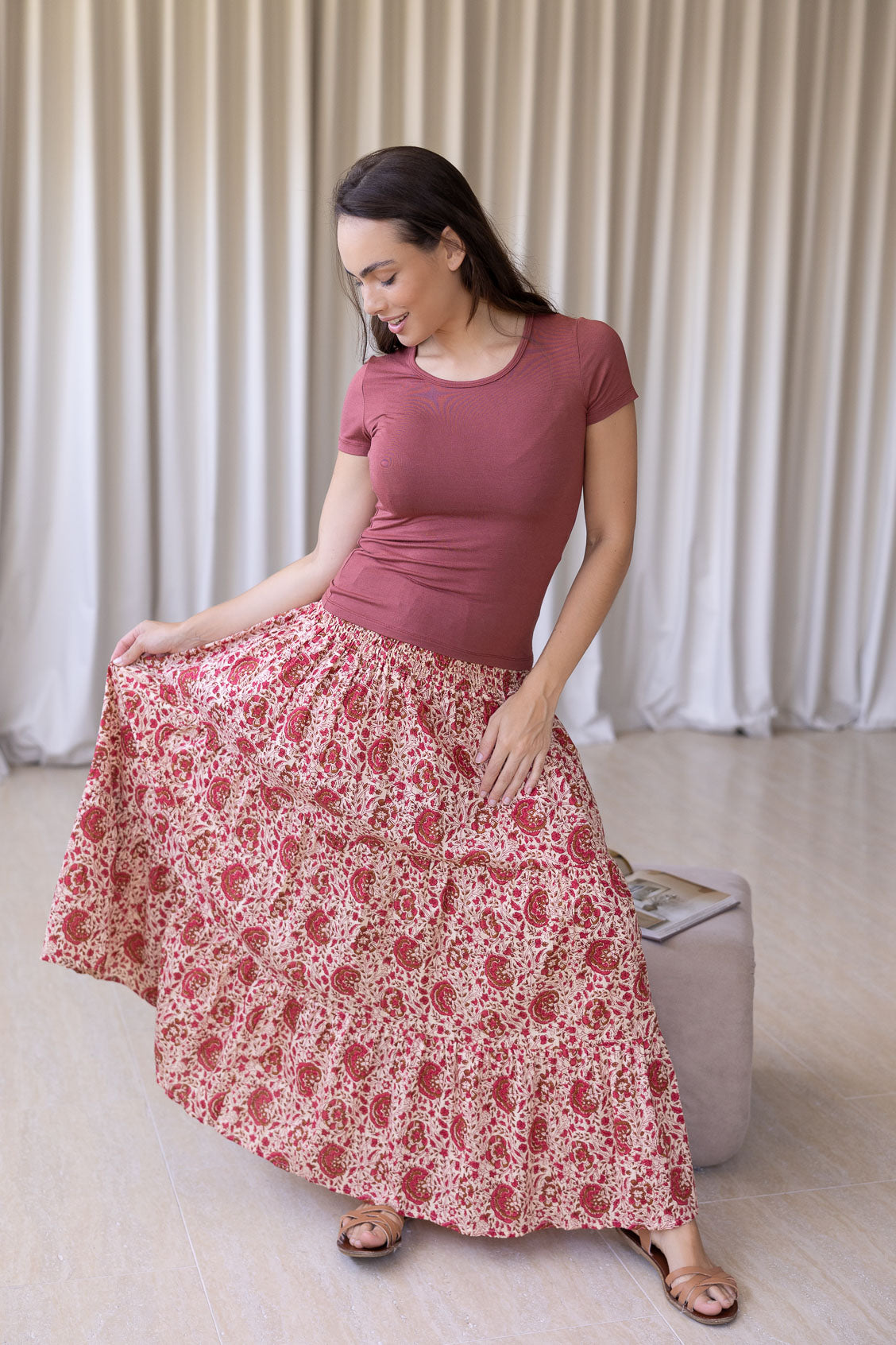 Model is wearing 100% cotton tiered maxi skirt in gentle cream based floral print with wide elasticated waistband.