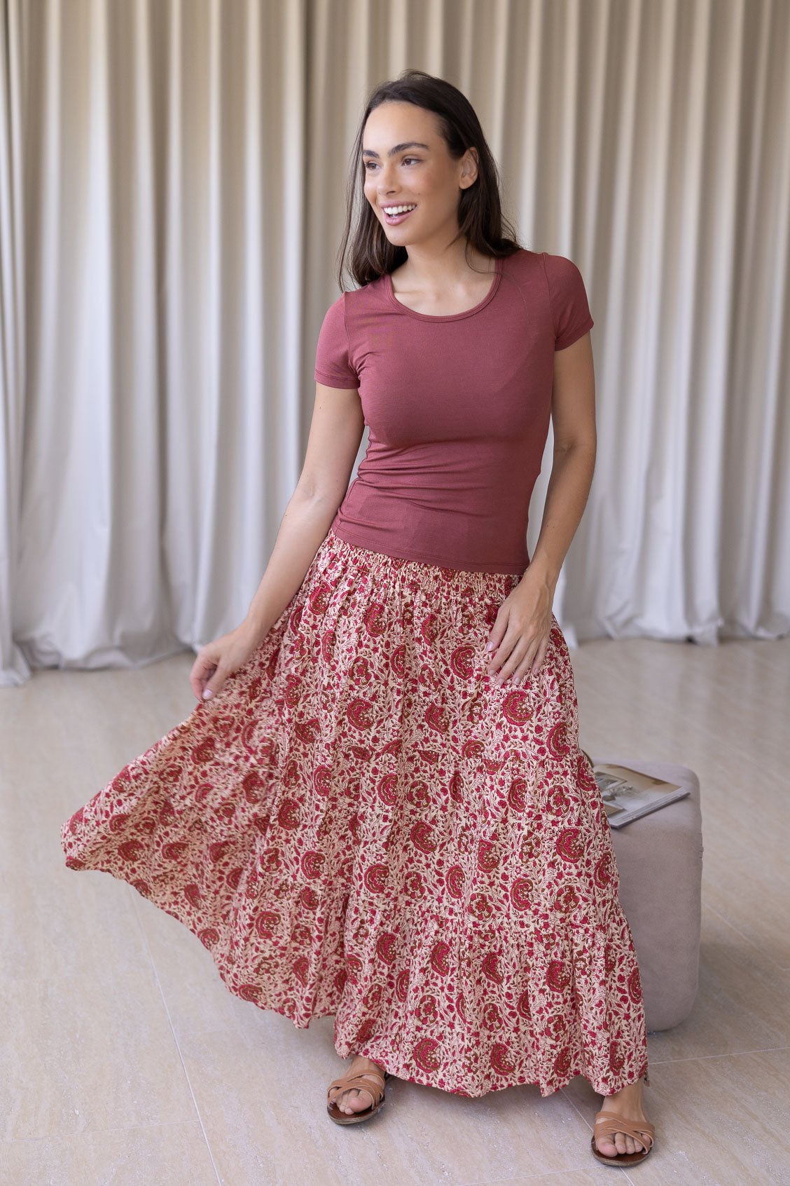 Model flaunting gentle cream based floral print cotton maxi skirt with a wide shirred elastic waistband.