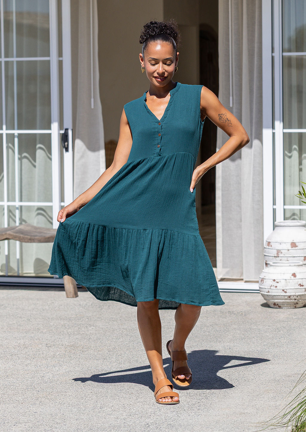 Front view of woman in the Ember Midi Dress Deep Teal with buttoned bodice