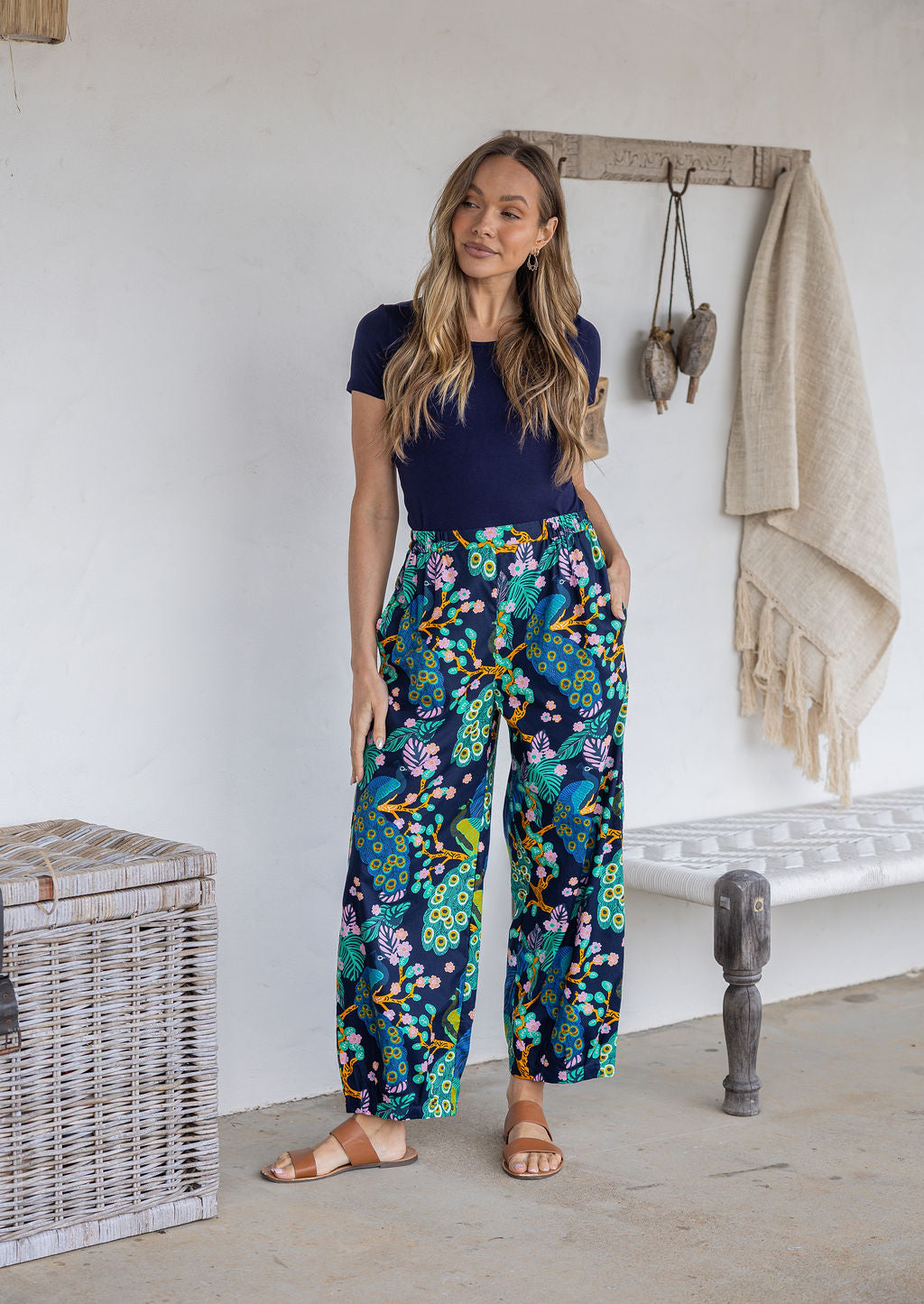 Woman wearing a 100% cotton wide leg pants in navy based multicolour floral print