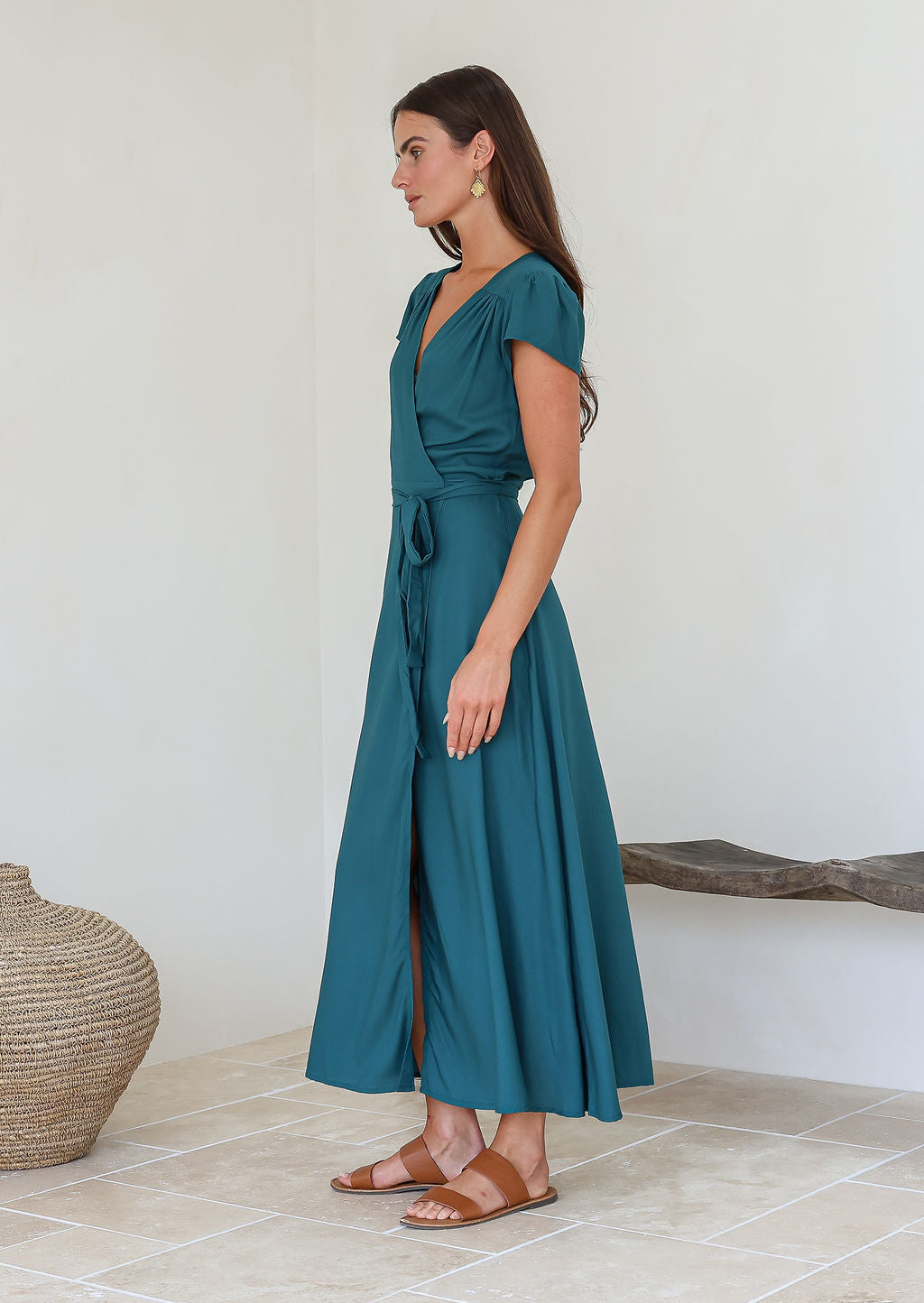Woman wearing a teal rayon wrap maxi dress with short sleeves