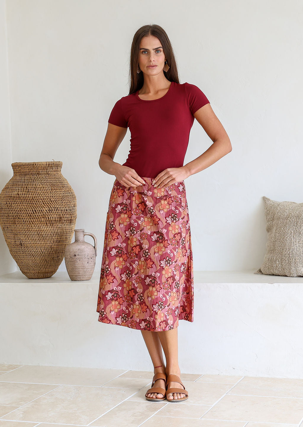 Model wearing 100% cotton knee length A-line skirt with side zipper and pockets in warm toned Japanese style print.