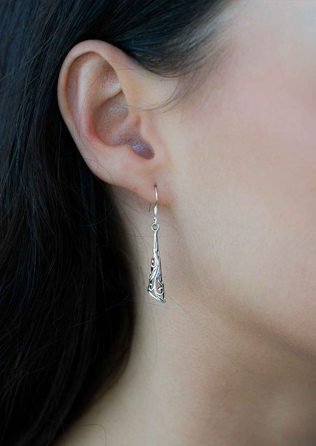 woman wearing long silver filigree drop earring 92.5 sterling silver