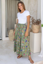 Model wears moss green based floral cotton maxi skirt with elastic waist and drawstring.