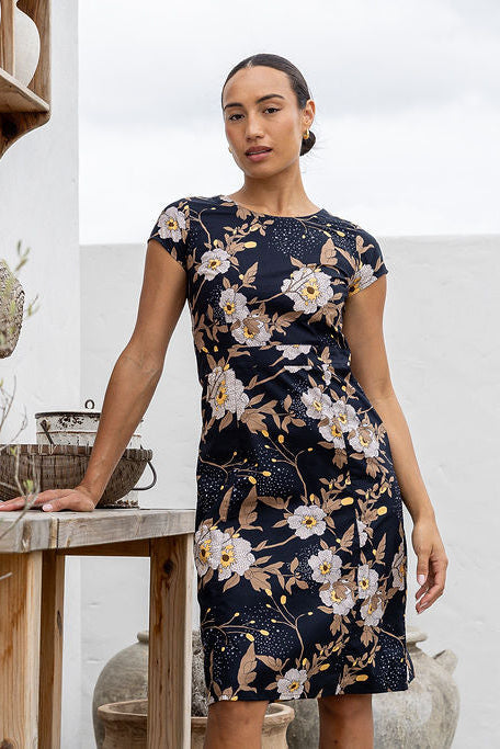 Woman wearing a 100% cotton, knee-length A-line floral dress.