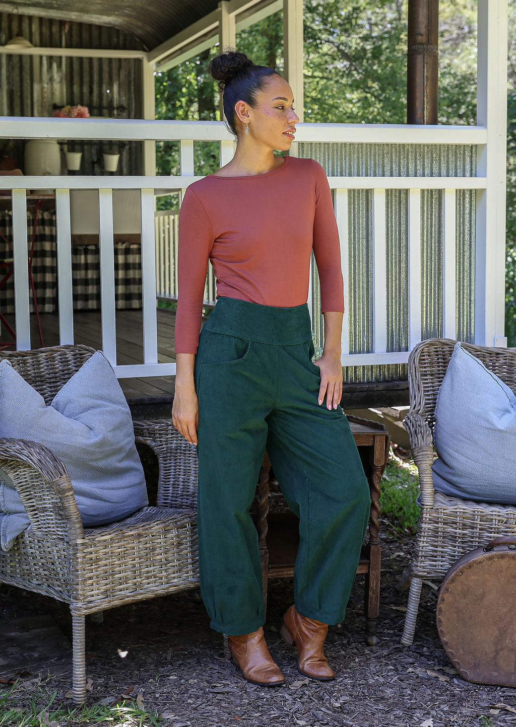 Woman wearing a cotton corduroy wide-leg dark green pants with basic top