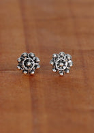 sterling silver round Indian stud earrings with an ornate pattern.