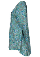 White and blue floral print top that is longer at the back.