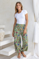 Model wears cotton harem pants with elasticated ankles, wide waistband and deep pockets.