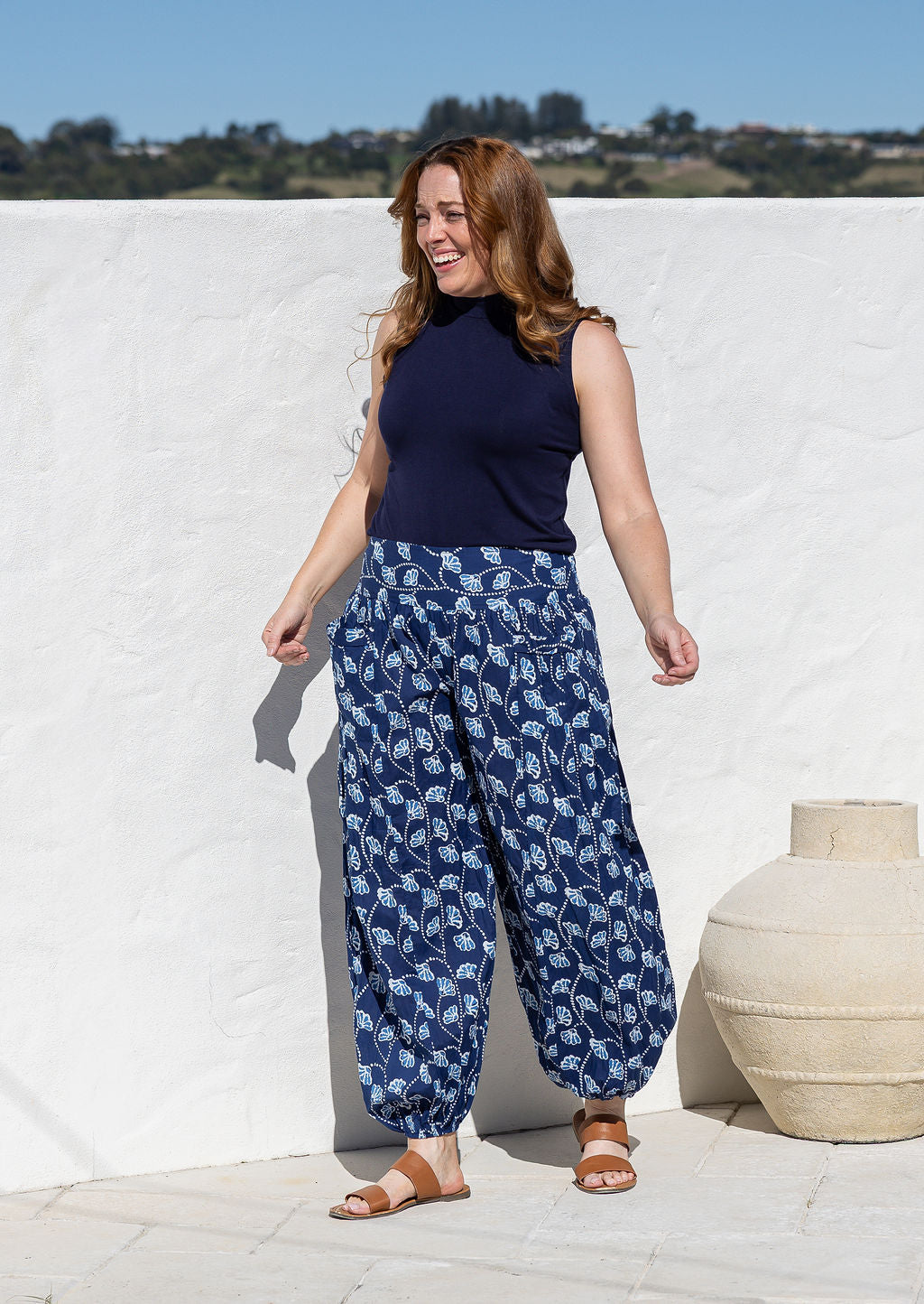 wearing a 100% cotton floral blue harem pants with flat wide waistband in front and elastic at the back.