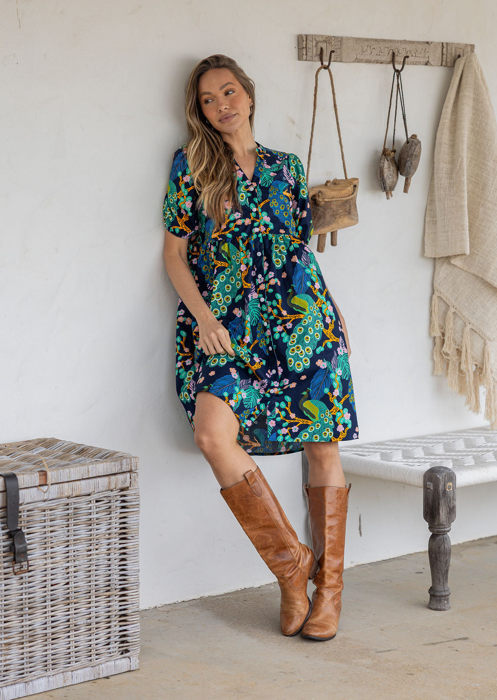 Woman wearing a knee length relaxed fit button through 100% cotton dress