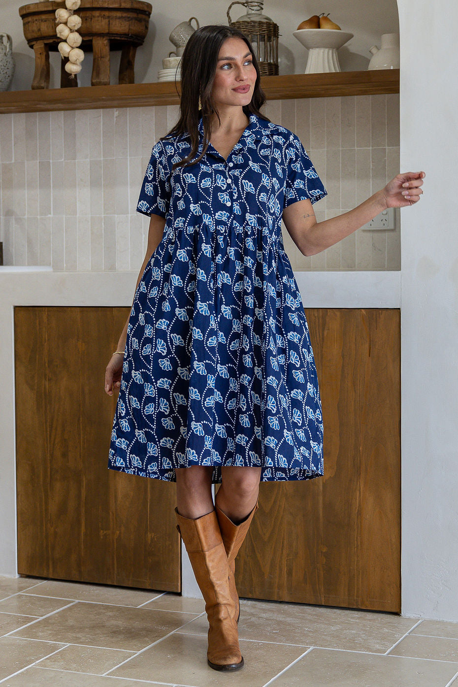 Woman wearing a 100% cotton navy blue base floral print relaxed fit collared short sleeve dress