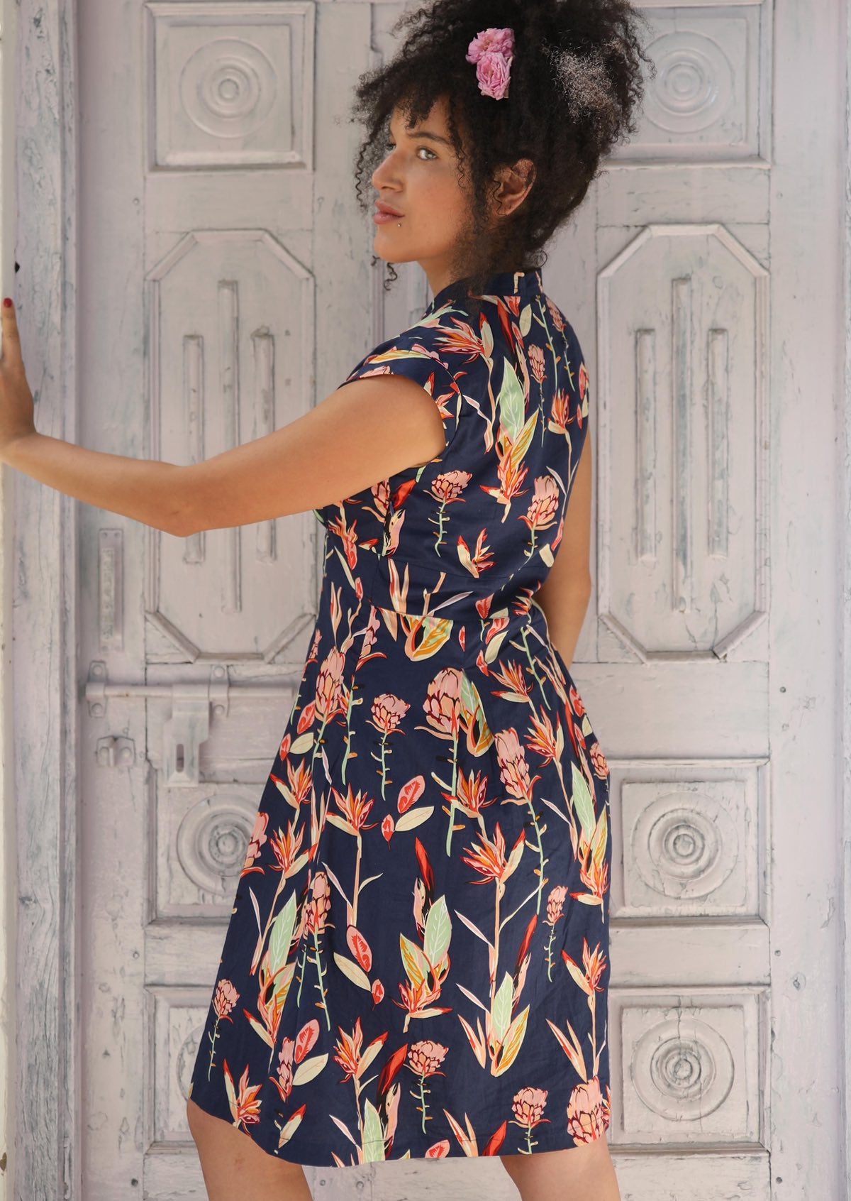Woman wearing  V-neck 100 percent Cotton Short Sleeve Dress tailored with cap sleeve, empire waistline and a-line skirt