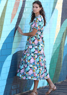 woman wearing 100% cotton midi dress in pastel spot print