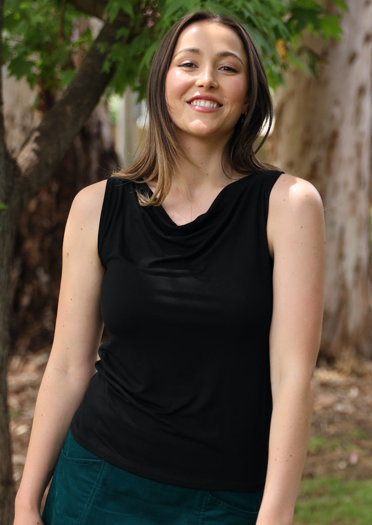 Woman wearing black cowl neck rayon singlet top