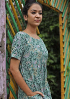 Model wearing round neck short sleeve dress with hands in pocket