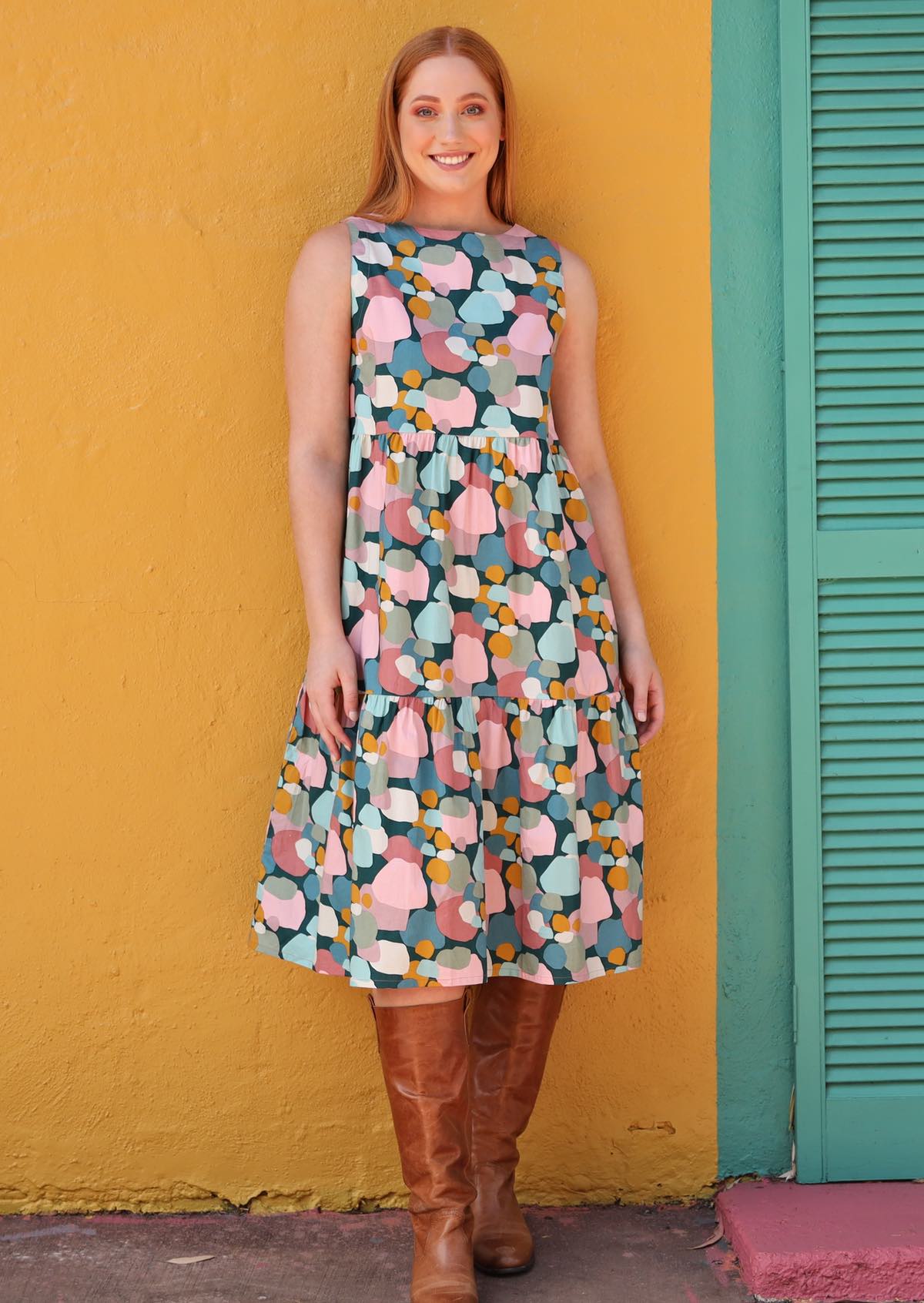Woman in high neck cotton midi dress in pastel spotty print.