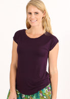 Woman with blonde hair wearing a soft flattering fit purple rayon jersey t-shirt.