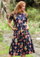 Woman wearing Dress with fitted bodice loose skirt with pockets