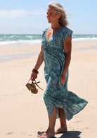 Model standing and wearing 100 percent cotton maxi dress with butterfly
sleeves and v-neck