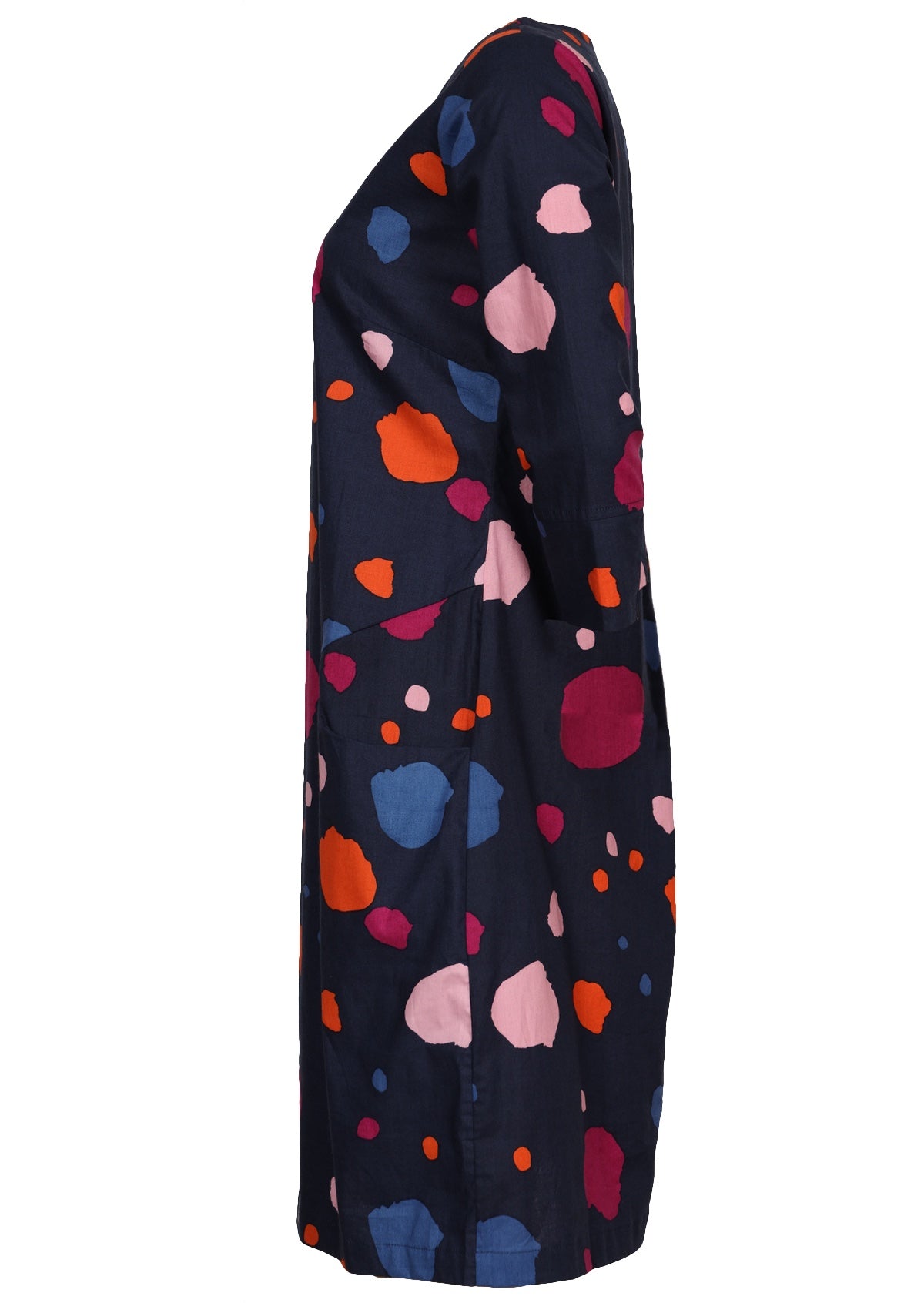 Side view of knee length cotton dress in bold spotty print on navy blue base.