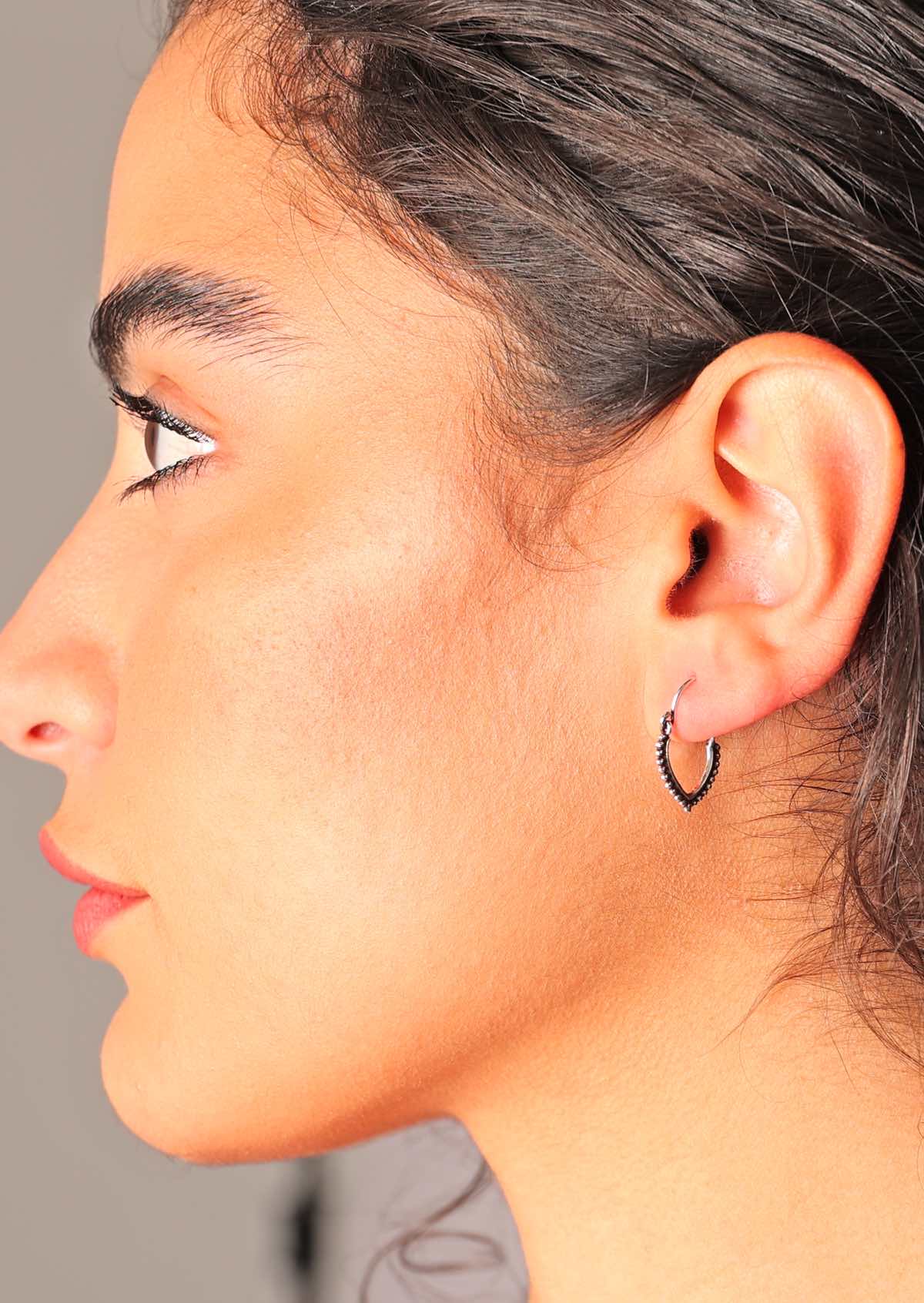 These sterling silver hoops form a Reuleaux triangle shape with silver beading along the outer edge