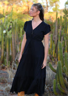 Model wears black rayon maxi dress with tiered, voluminous skirt and elasticised waistband