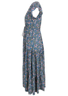 Side view of blue based block style floral print rayon dress with pockets.
