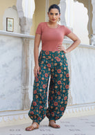 Model pairs floral printed green cotton harem pants with our scoop neck T shirt  in dusty rose