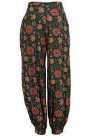 Front image of green based floral print cotton harem pants with pockets and cuffed ankles.