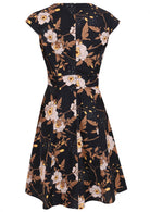 Back view of 100% cotton dress with print featuring white blooms, tan foliage, and warm buttercup highlights on a black base.