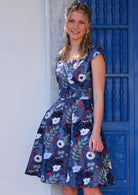 Model wearing floral 100 percent cotton cross over retro dress navy with pockets 