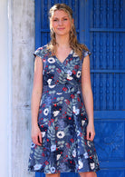 Model wearing floral 100 percent cotton cross over retro dress navy 