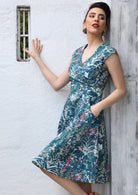 woman wearing the Alice Dress Verdure showing the flattering fit and floral print.