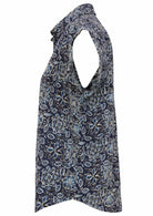 Side view of loose fit shirt style cotton top with collar in navy blue based floral print