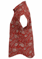 Side view of loose fit shirt style cotton top with collar in red based floral print.