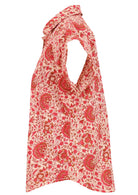 Side view of loose fit shirt style cotton top with collar in cream based floral print.