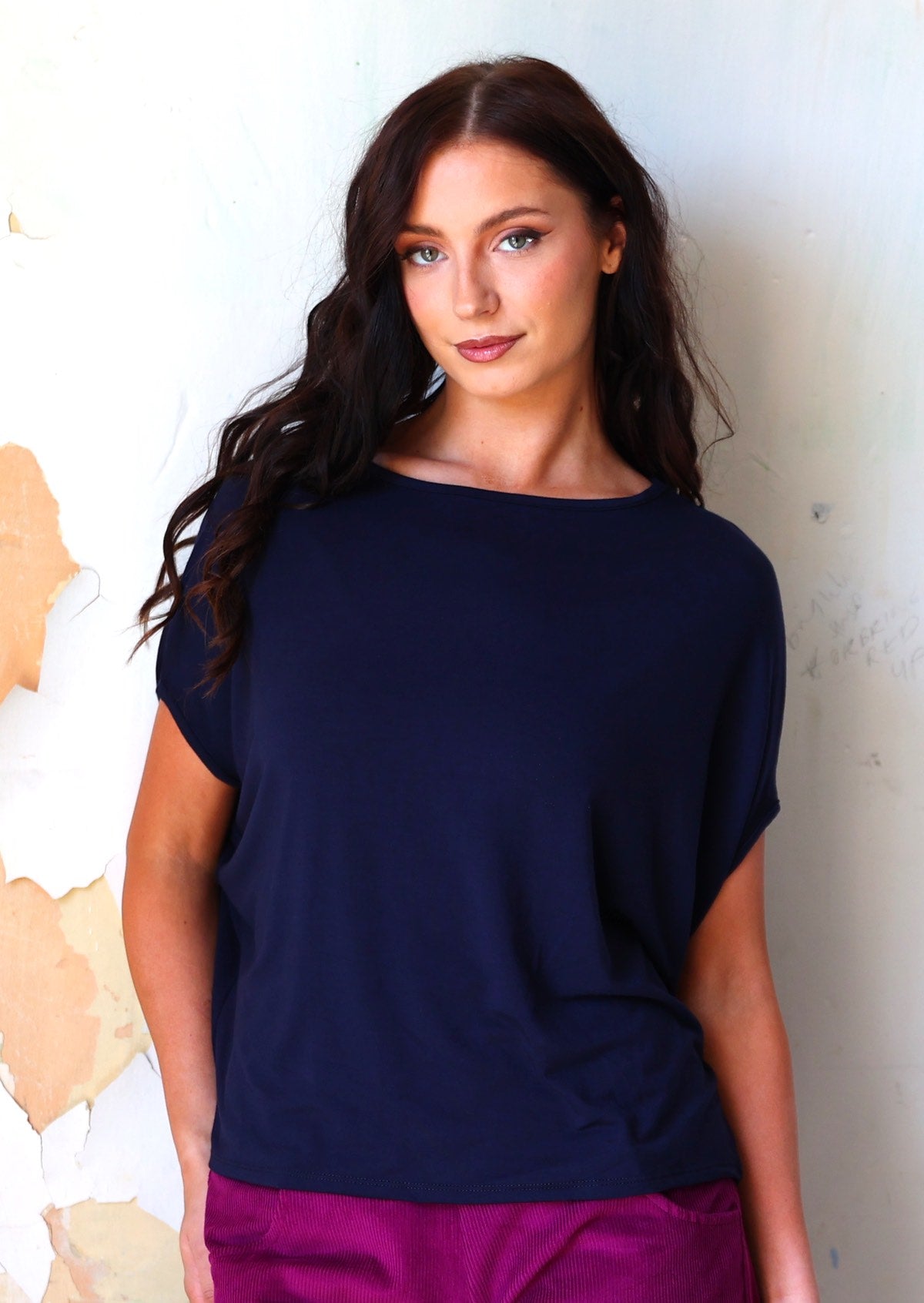 Woman wearing navy blue batwing t-shirt 