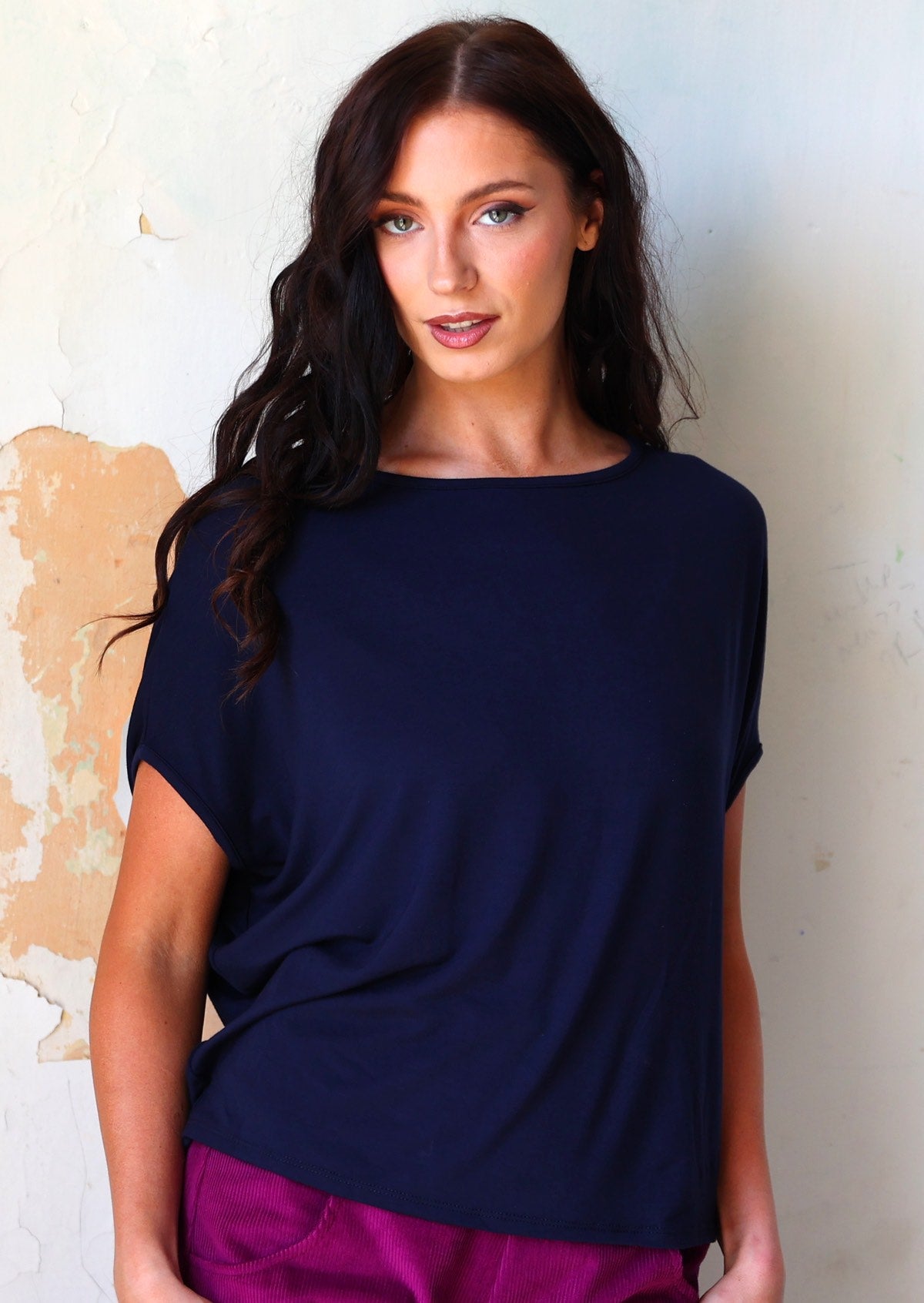 Woman wearing navy blue rayon batwing 