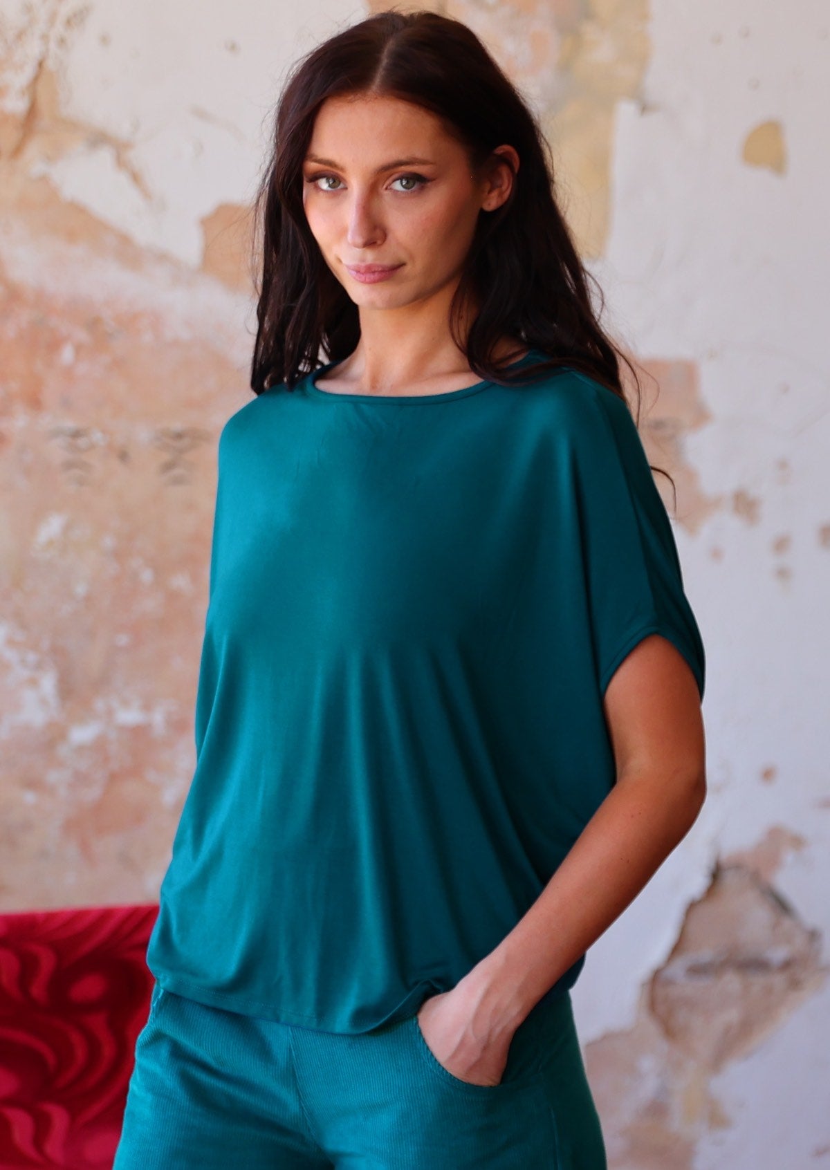 woman in teal rayon batwing t-shirt 