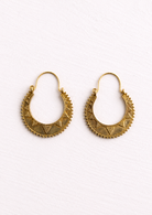 Rounded crescent hoop earrings inspired by traditional Indian jewellery. The raised bead edging and textured triangle detailing give it a lovely handcrafted feel, adding interest and shine. Placed on a white background. 