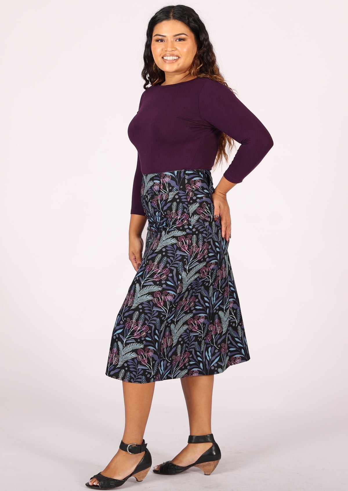 Model wears cotton midi length A-line skirt with belt loops and back pockets