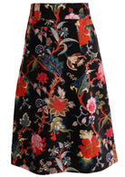Back view of cotton velvet midi length A-line skirt with back pockets, in multi-coloured Jacobean floral print on a black base