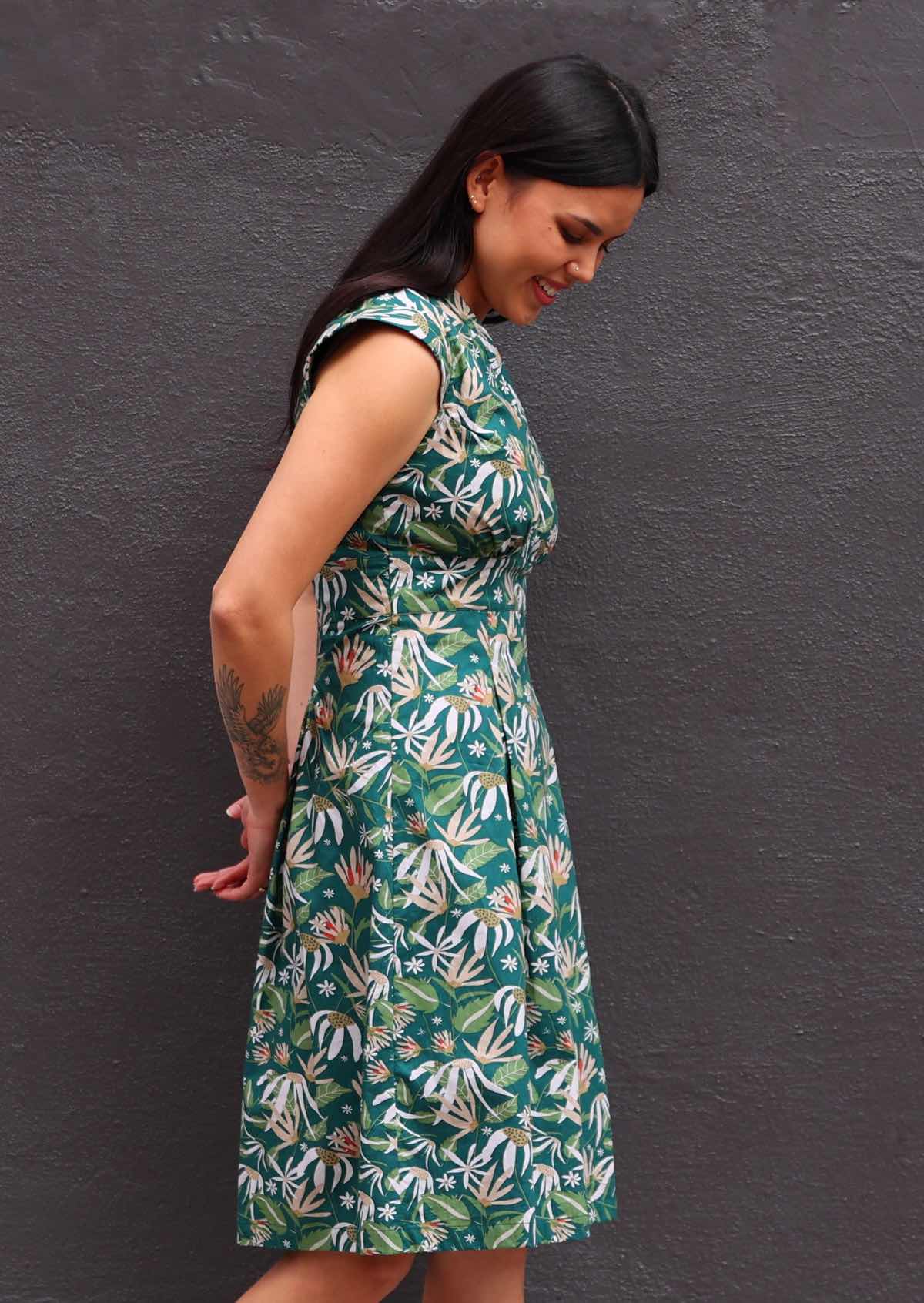 Model side view wearing Flannel Flower floral dress with dark green background 100 percent cotton retro style 