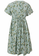 Back view of a pale mint green based floral cotton button through dress with short sleeves and shoestring waist ties