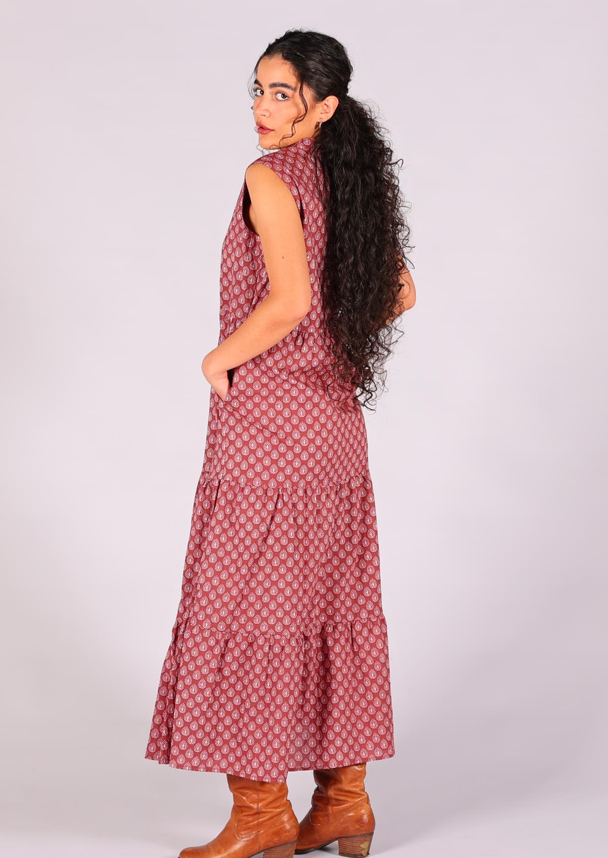 Model looking over her shoulder wearing the Boho Maxi dress dark terracotta with white pendant Indian block print 100% cotton sleeveless dress