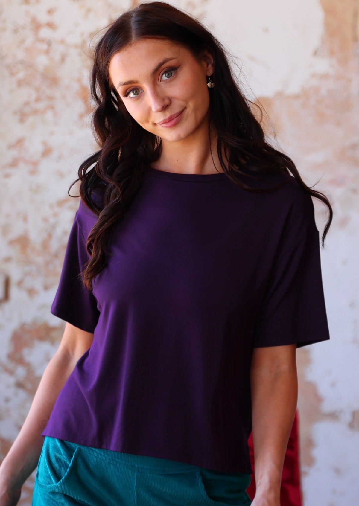 Woman wearing loose fit dark purple rayon tee