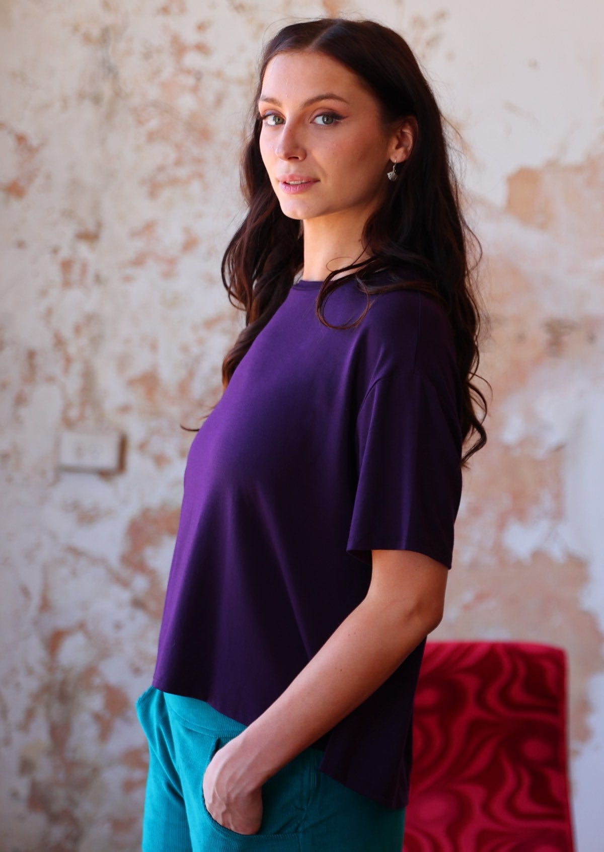 Woman wearing loose fit dark purple rayon top