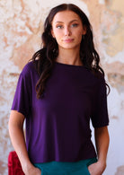 Woman wearing loose fit dark purple rayon t-shirt